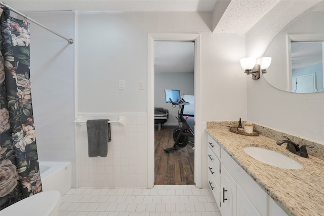 full bathroom with vanity, toilet, shower / bath combo, tile patterned floors, and a textured ceiling