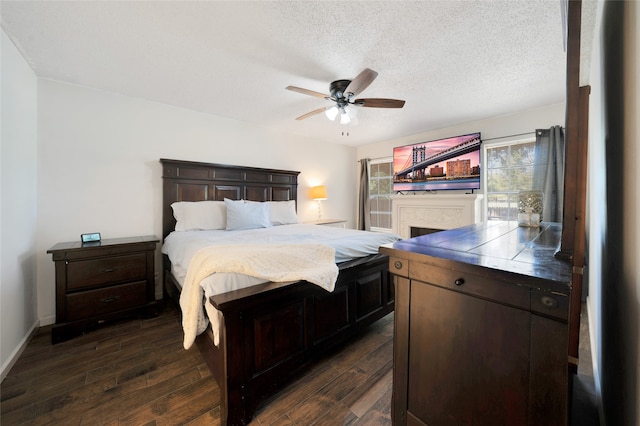 bedroom featuring a textured ceiling, dark wood-type flooring, and ceiling fan