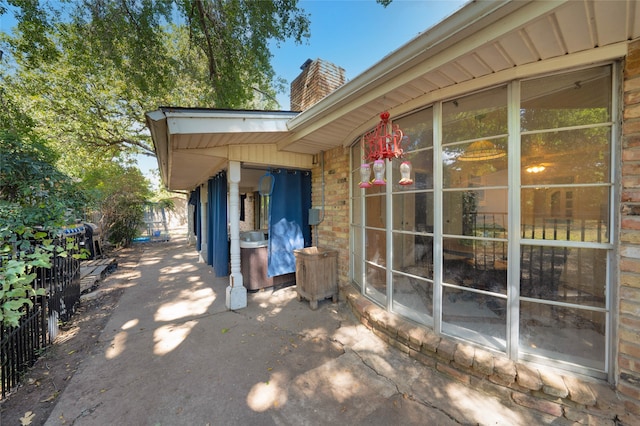 view of property exterior with a patio area