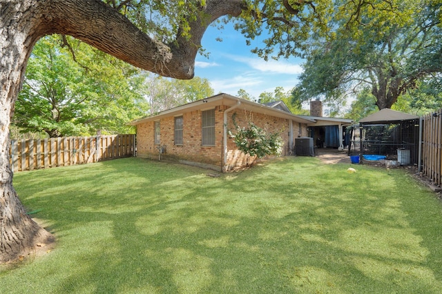 view of yard with a gazebo and central air condition unit