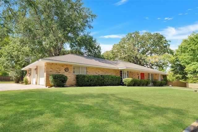 single story home featuring a garage and a front yard