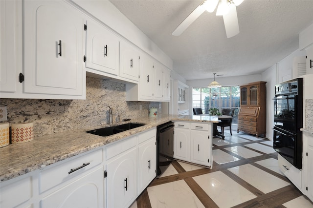 kitchen featuring black appliances, sink, white cabinets, kitchen peninsula, and a textured ceiling