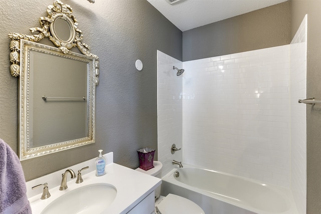 full bathroom featuring a textured ceiling, bathing tub / shower combination, vanity, and toilet