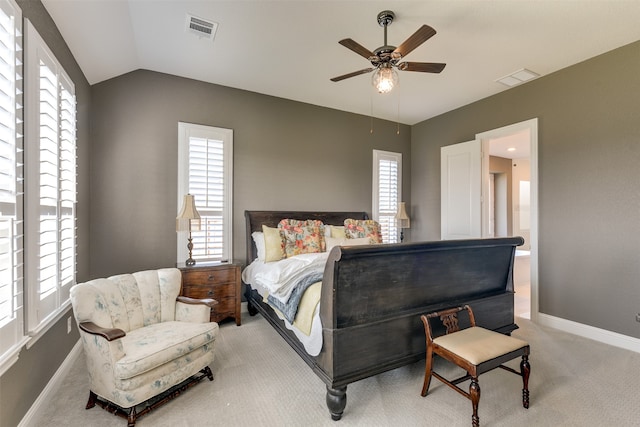 bedroom with ceiling fan, light colored carpet, vaulted ceiling, and multiple windows