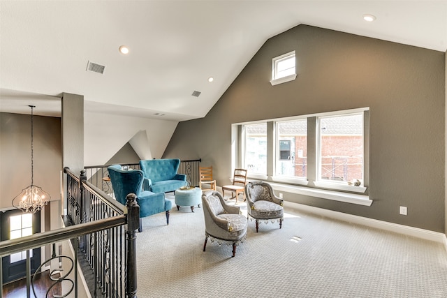 sitting room featuring carpet floors, a healthy amount of sunlight, lofted ceiling, and a notable chandelier