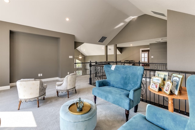 carpeted living room with lofted ceiling