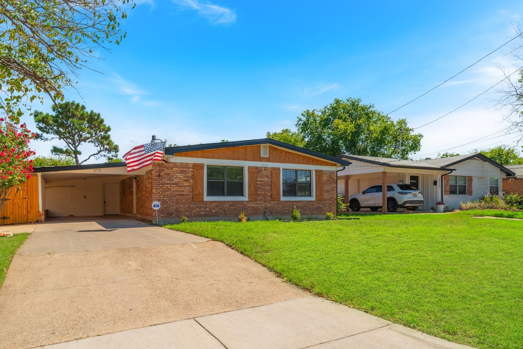 single story home featuring a front yard and a carport