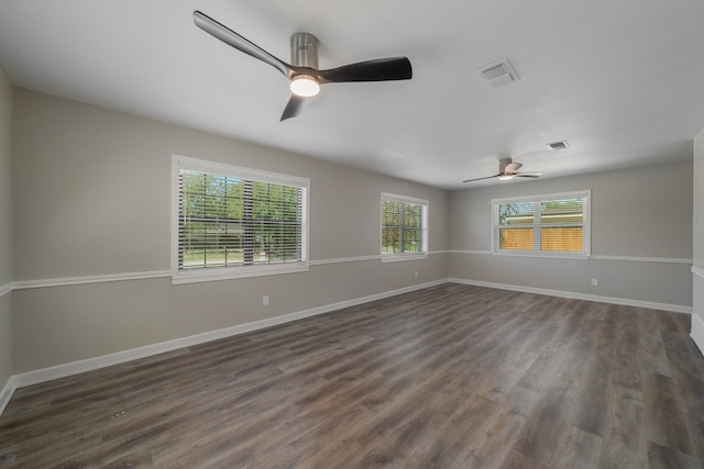 unfurnished room with dark hardwood / wood-style floors and ceiling fan