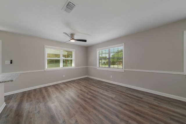 spare room with ceiling fan and dark hardwood / wood-style floors