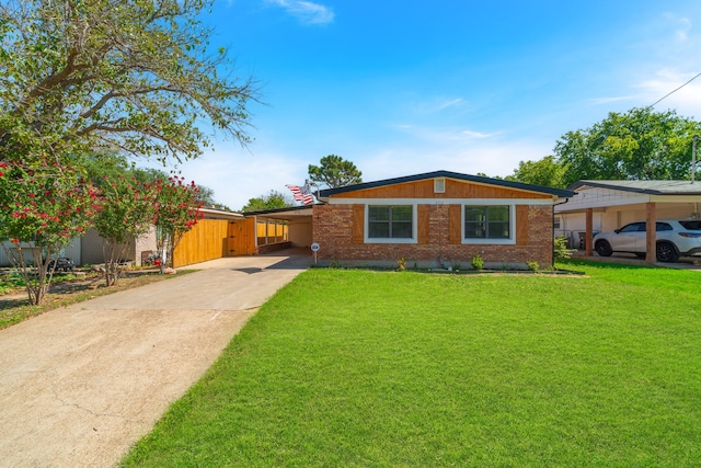 ranch-style house featuring a front yard and a carport