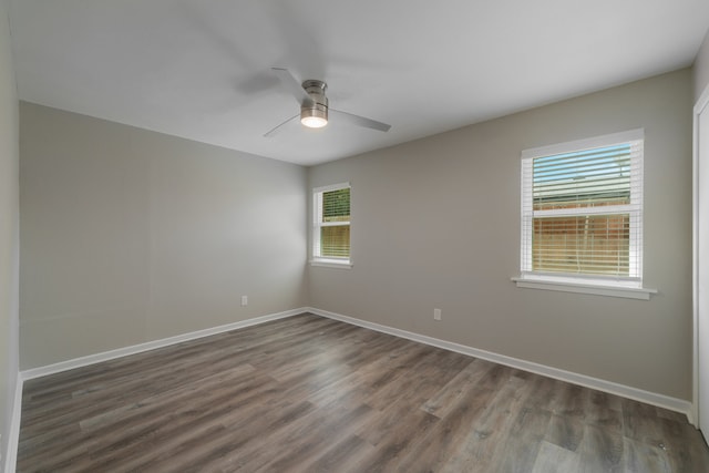 empty room featuring ceiling fan and dark hardwood / wood-style flooring