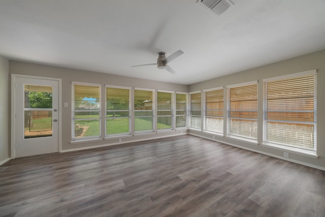 unfurnished sunroom with a healthy amount of sunlight and ceiling fan