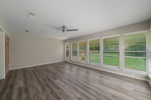 empty room featuring ceiling fan and dark hardwood / wood-style flooring