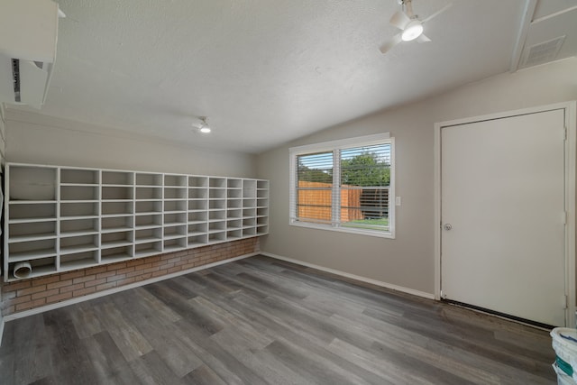 interior space featuring wood-type flooring, a textured ceiling, lofted ceiling, and ceiling fan