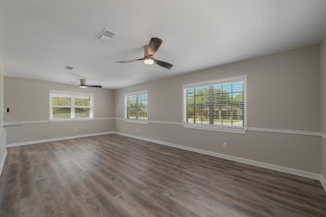 empty room with ceiling fan and dark hardwood / wood-style floors