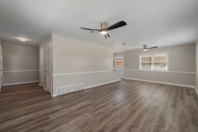 empty room with ceiling fan and dark hardwood / wood-style flooring