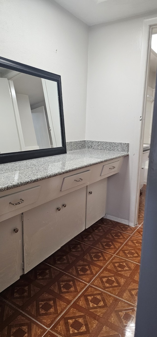 bathroom with parquet flooring and vanity