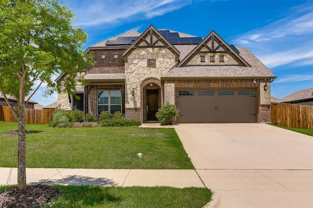 view of front of house featuring a garage, solar panels, and a front lawn