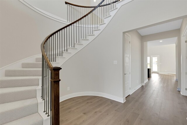 stairway featuring hardwood / wood-style flooring