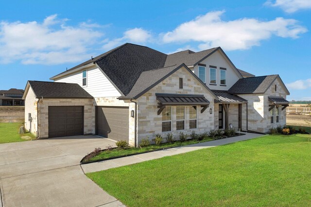 view of front of property featuring a front yard and a garage