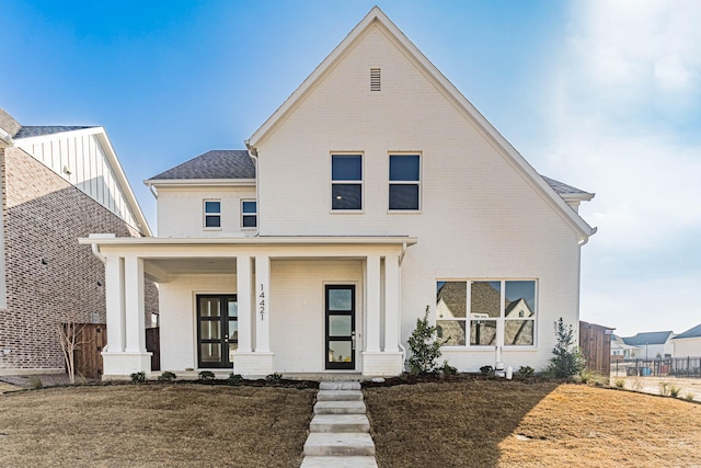 view of front of house featuring a porch and a front lawn