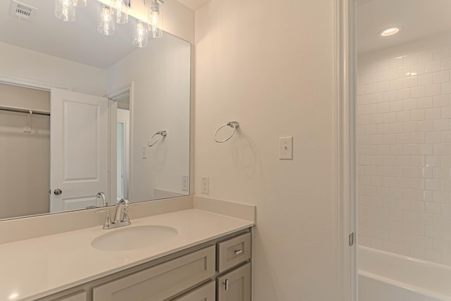 bathroom featuring vanity and tiled shower / bath combo