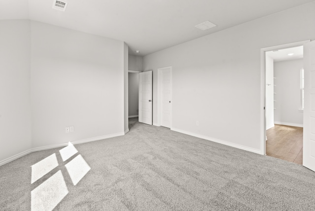 unfurnished bedroom featuring light carpet