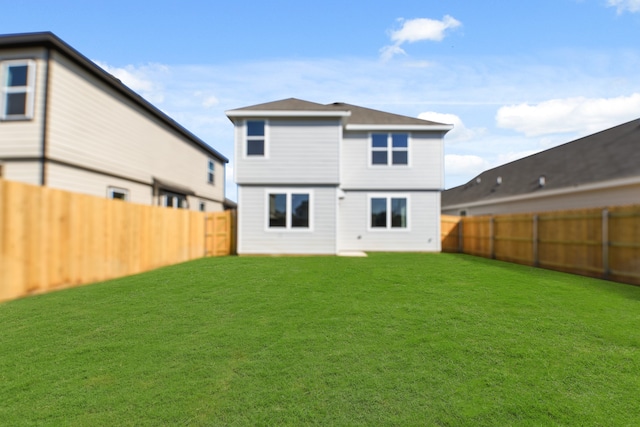 rear view of house with a yard