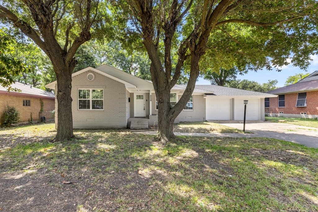 ranch-style home featuring a garage