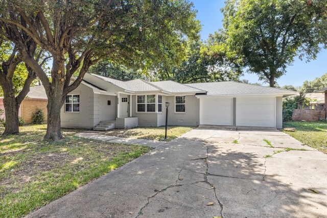 ranch-style house featuring a front yard and a garage