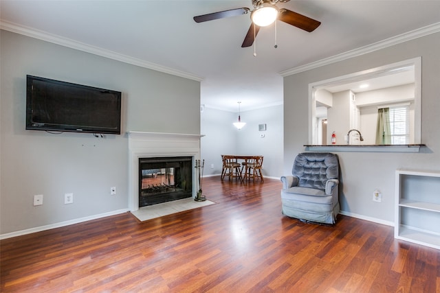 interior space with ornamental molding, wood-type flooring, and a multi sided fireplace