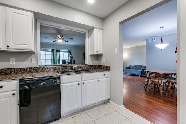 kitchen featuring white cabinets, black dishwasher, light wood-type flooring, and sink