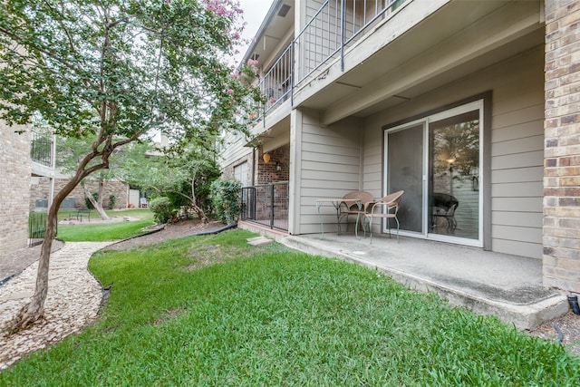 view of yard with a patio and a balcony