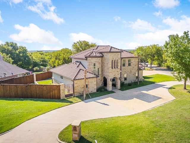 mediterranean / spanish home featuring a front lawn