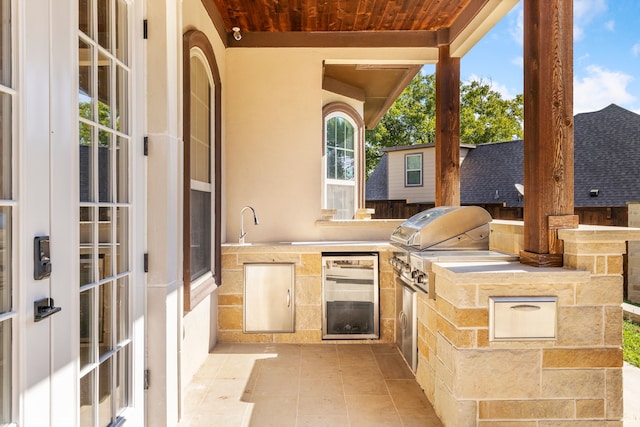 view of patio with grilling area and an outdoor kitchen