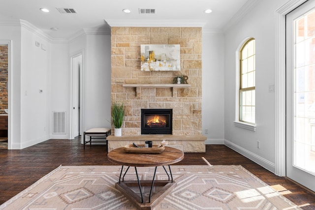 living room featuring crown molding, a fireplace, and dark hardwood / wood-style flooring