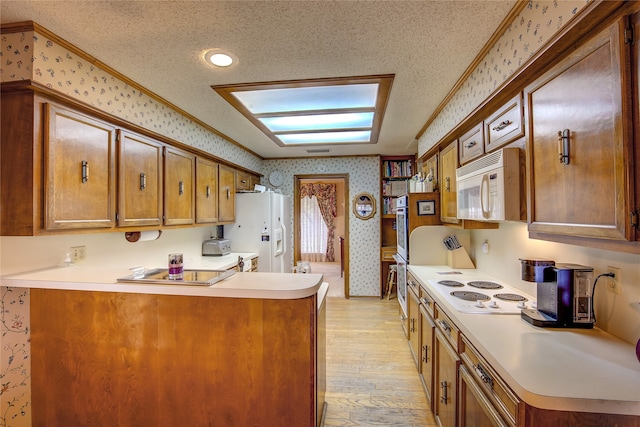 kitchen featuring ornamental molding, white appliances, a textured ceiling, and light hardwood / wood-style flooring