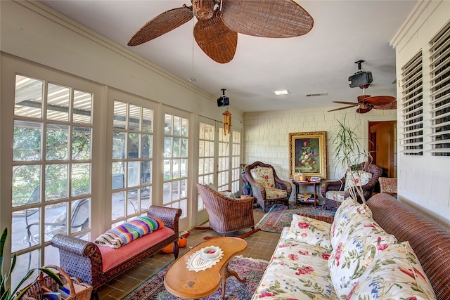 sunroom / solarium featuring ceiling fan