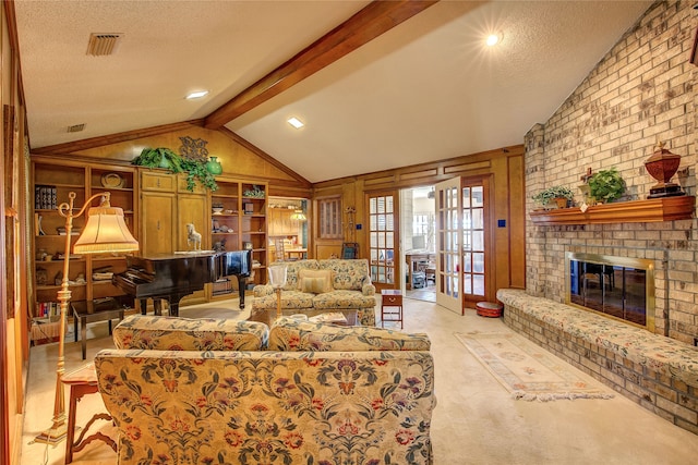 living room featuring french doors, vaulted ceiling with beams, a textured ceiling, and a fireplace