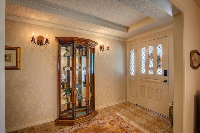 entrance foyer with a textured ceiling and a raised ceiling