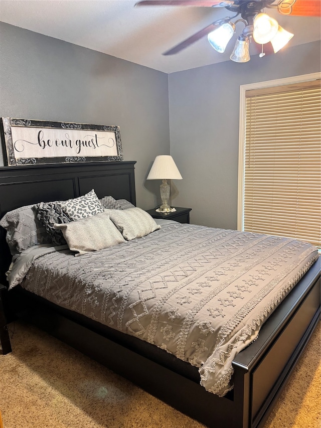 bedroom with ceiling fan and carpet flooring