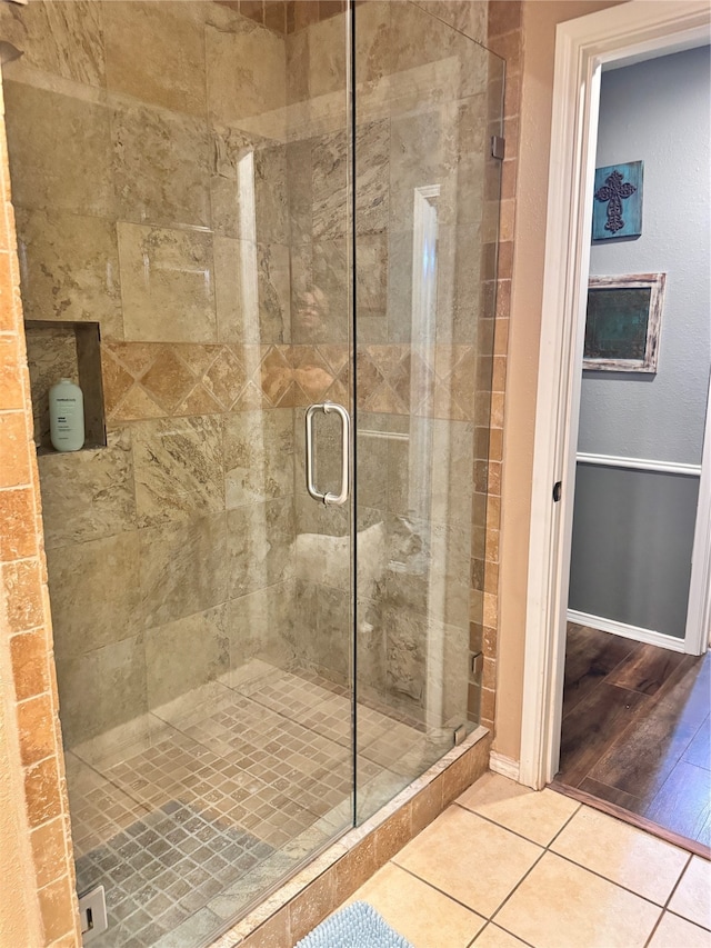 bathroom featuring hardwood / wood-style floors and a shower with door