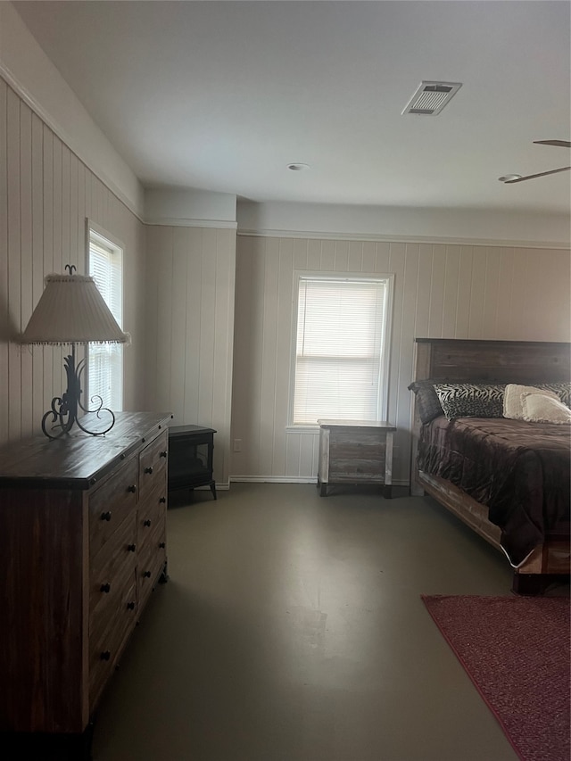 bedroom featuring wood walls