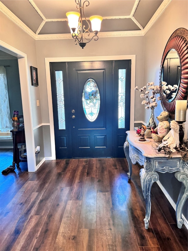 entrance foyer featuring an inviting chandelier, dark hardwood / wood-style floors, and crown molding