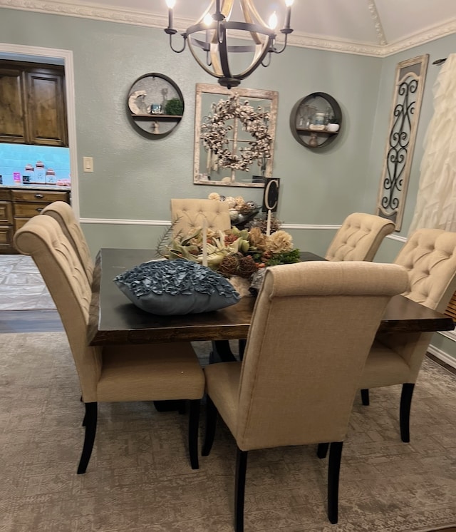 dining space featuring crown molding and an inviting chandelier