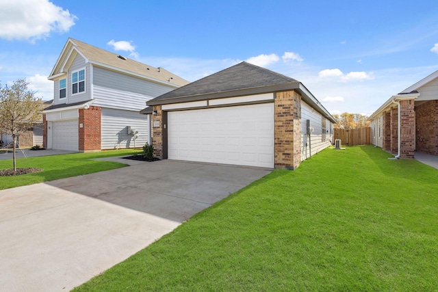 view of side of home featuring a garage and a lawn