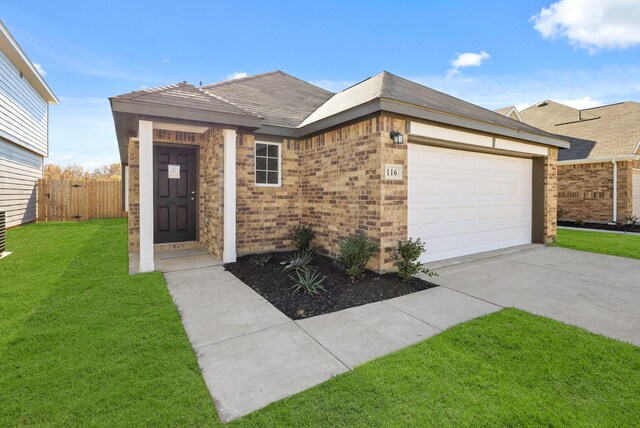 view of front of home featuring a front yard and a garage