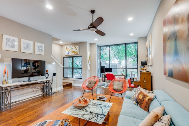 living room with wood-type flooring and ceiling fan