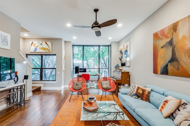 living room featuring ceiling fan and dark wood-type flooring