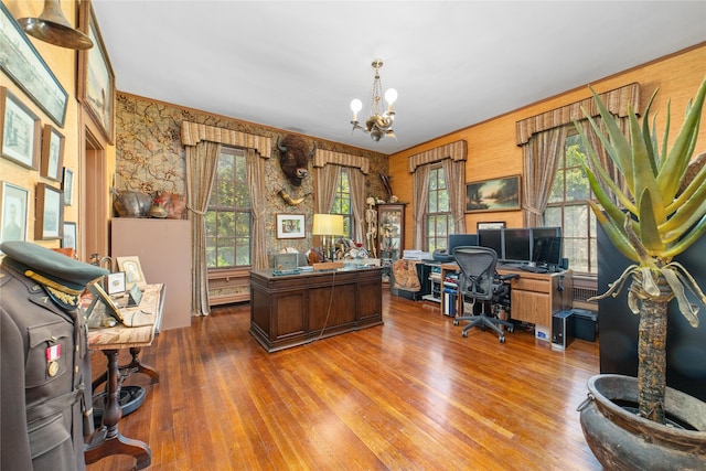 home office with a notable chandelier and light wood-type flooring